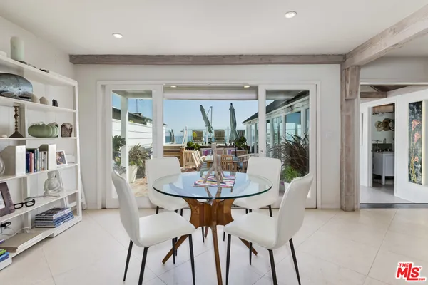 a dining room with furniture and a floor to ceiling window