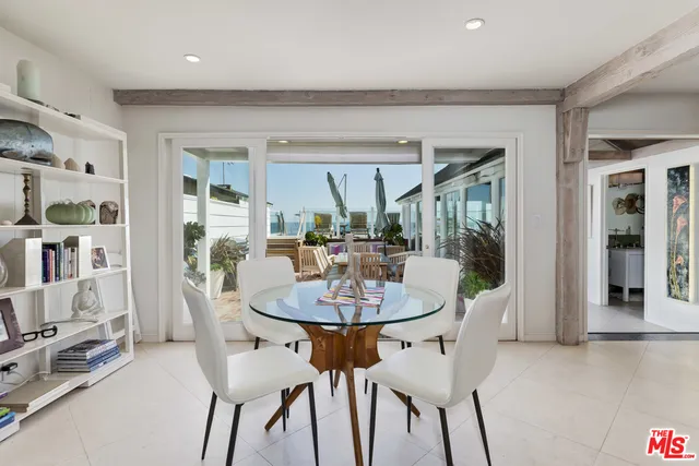 a dining room with furniture and a floor to ceiling window