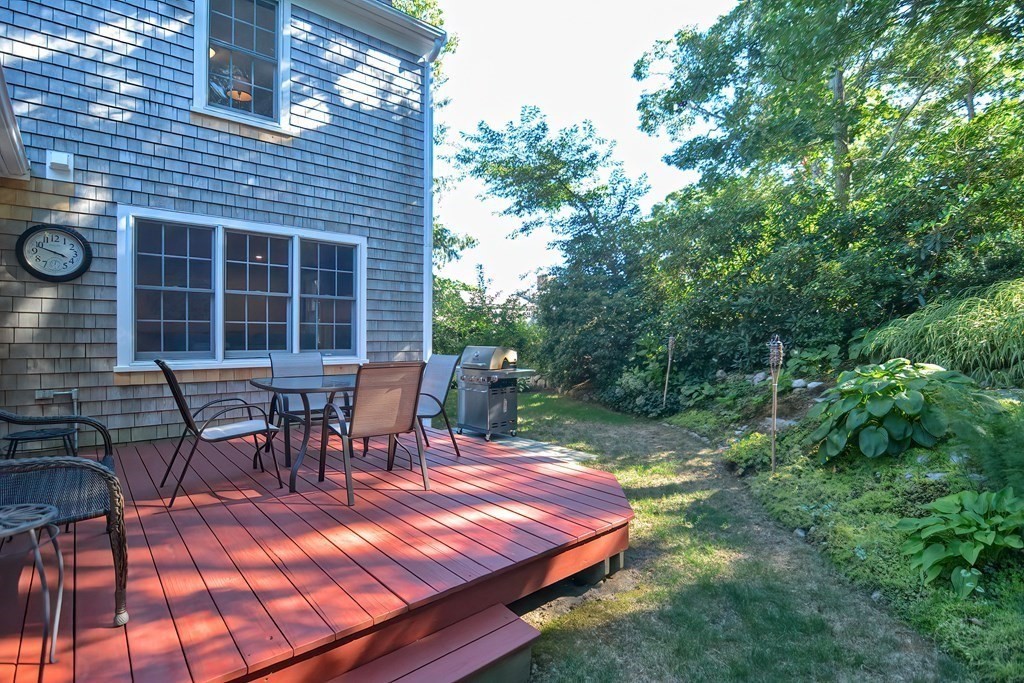 5 Tower Hill Drive Sandwich, MA 02563 - Photo 37 of 41 a view of a patio with table and chairs with wooden floor and fence