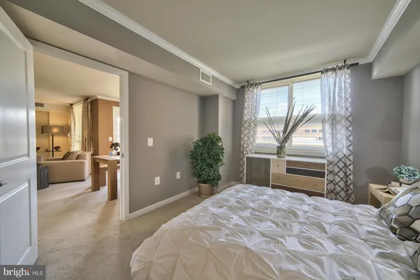 a bedroom with a bed and a view of bathroom