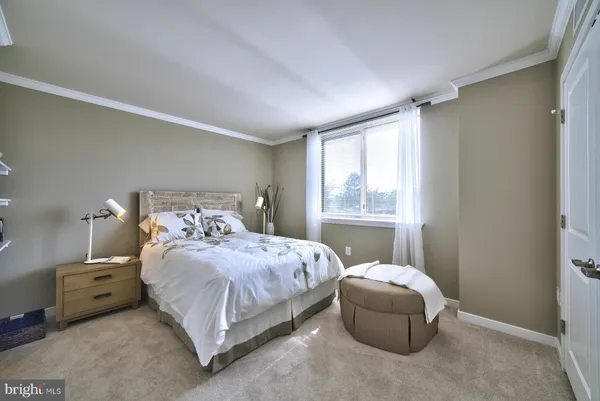 a bedroom with a bed and a mirror