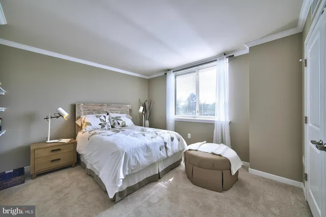 a bedroom with a bed and a mirror