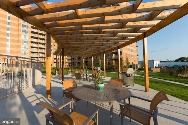 a view of a house with a swimming pool and sitting area