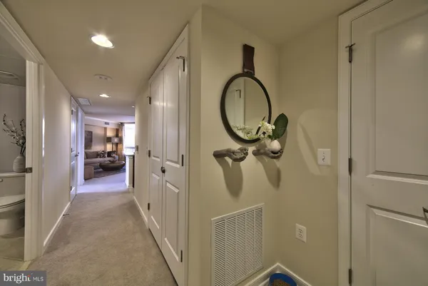a view of a hallway with wooden floor
