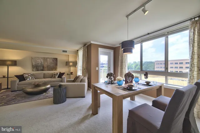 a work room with furniture and a large window