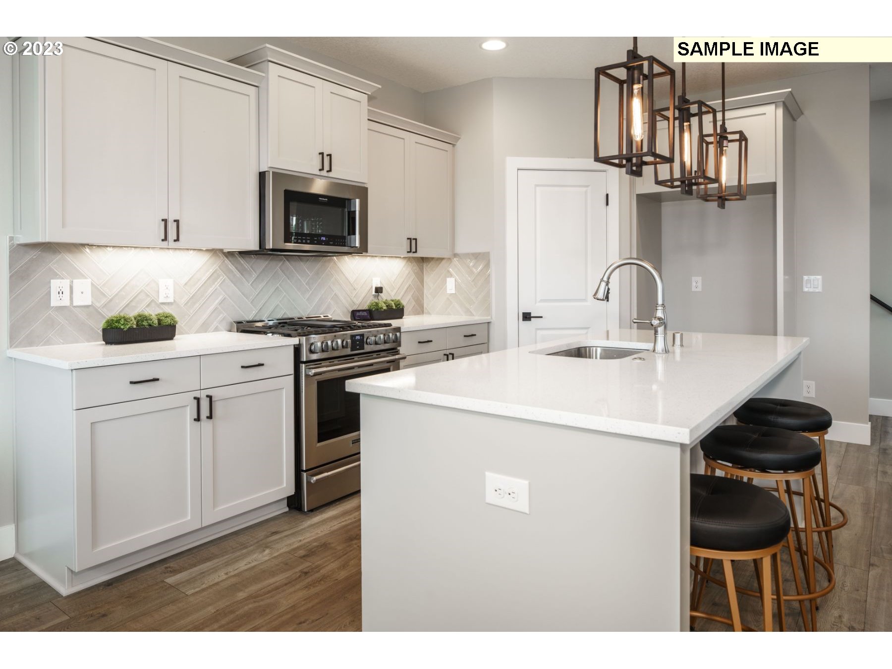 808 Northwest 178th Street Ridgefield, WA 98642 - Photo 8 of 21 a kitchen with a sink and white cabinets