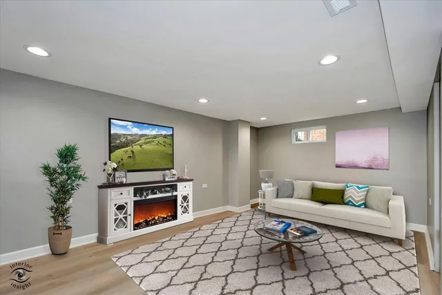 a living room with furniture a fireplace and a flat screen tv