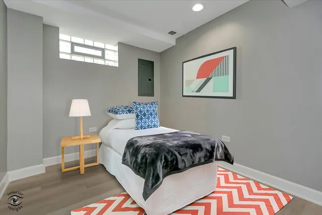 a bedroom with a bed and painting on the wall