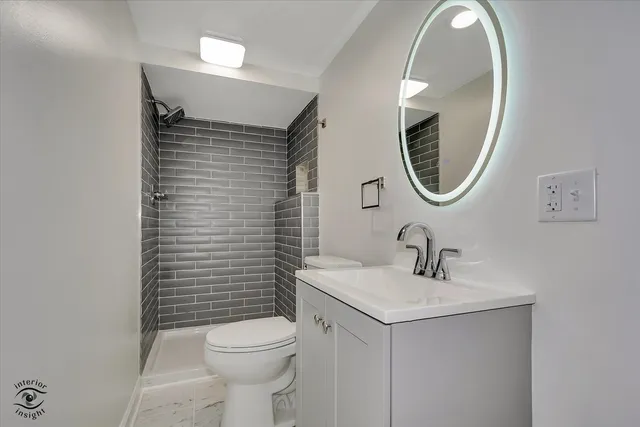 a bathroom with a sink a toilet and a mirror