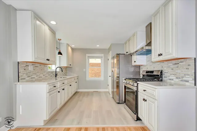 a large kitchen with stainless steel appliances granite countertop a stove a sink dishwasher and a refrigerator