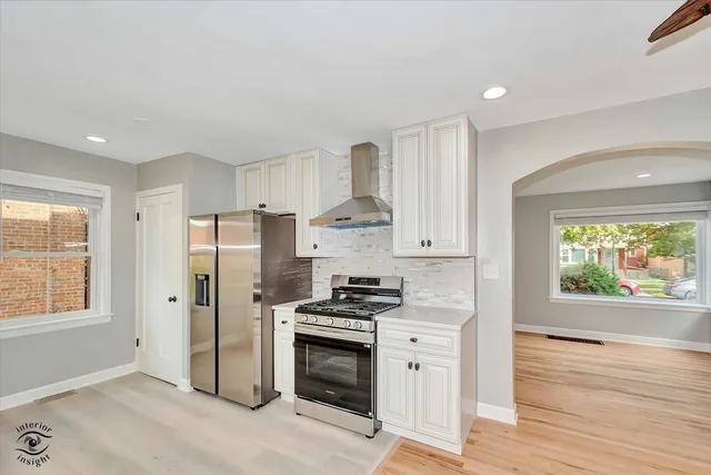 a kitchen with stainless steel appliances a refrigerator sink and stove
