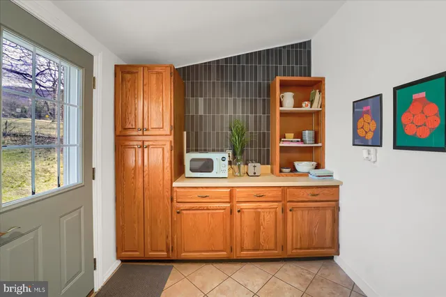 a room with painting and a lamp