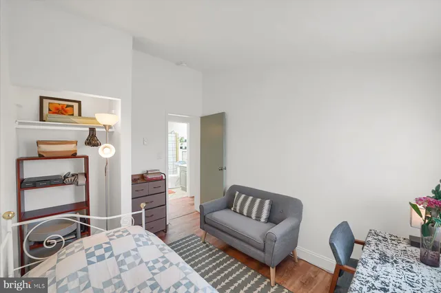 a bedroom with furniture and a window