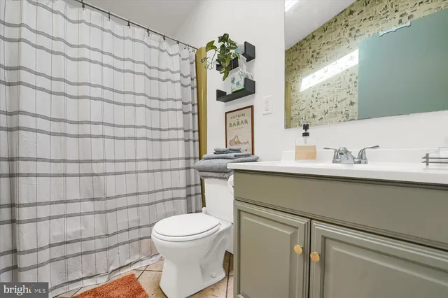 a bathroom with a toilet sink and shower