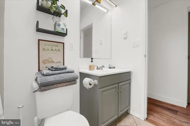 a bathroom with a sink a toilet and mirror