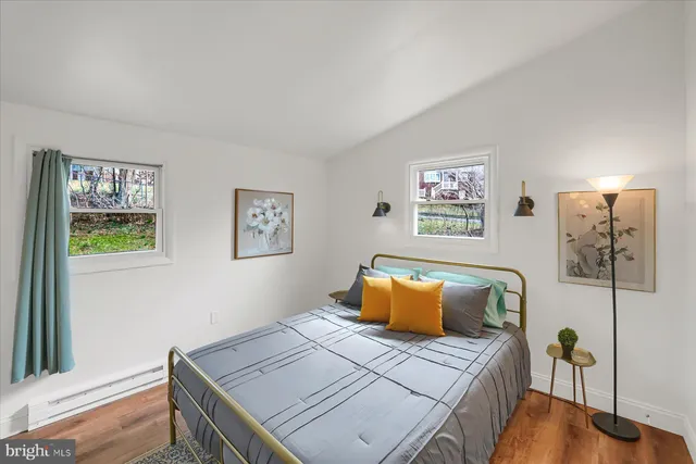 a bedroom with furniture and wooden floor