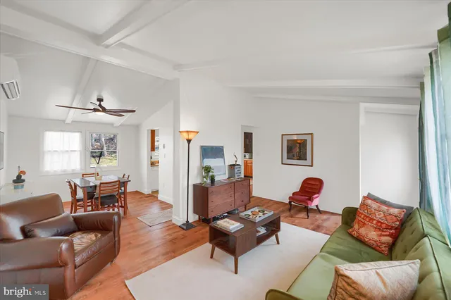 a living room with furniture rug and wooden floor