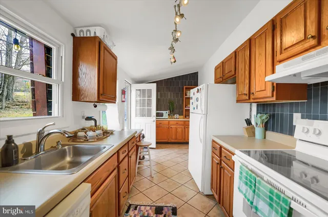 a kitchen that has a sink and a stove in it