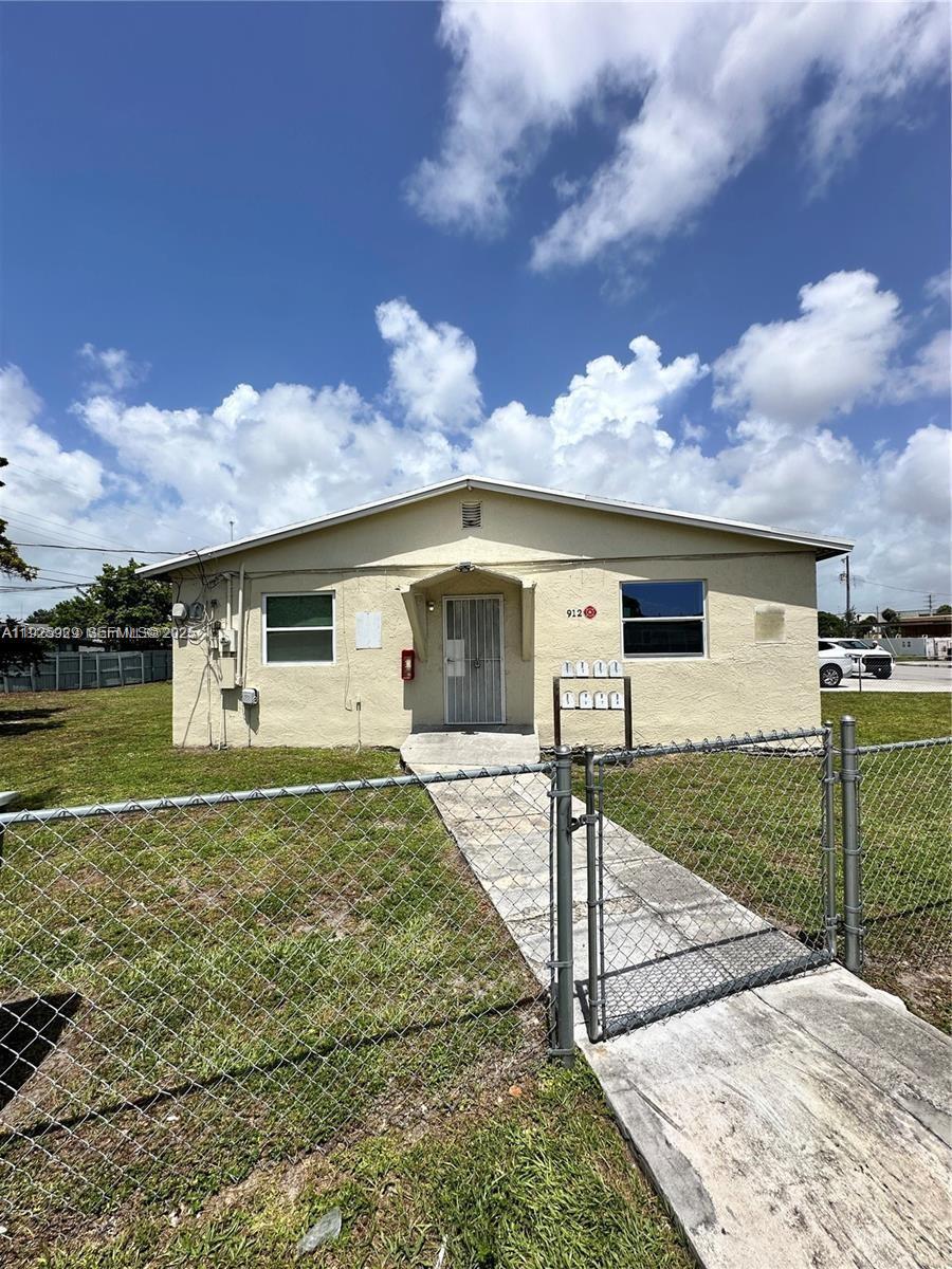912 Northwest 9th Avenue, Unit 8 Hallandale Beach, FL 33009 - Photo 1 of 10 a front view of a house with garden