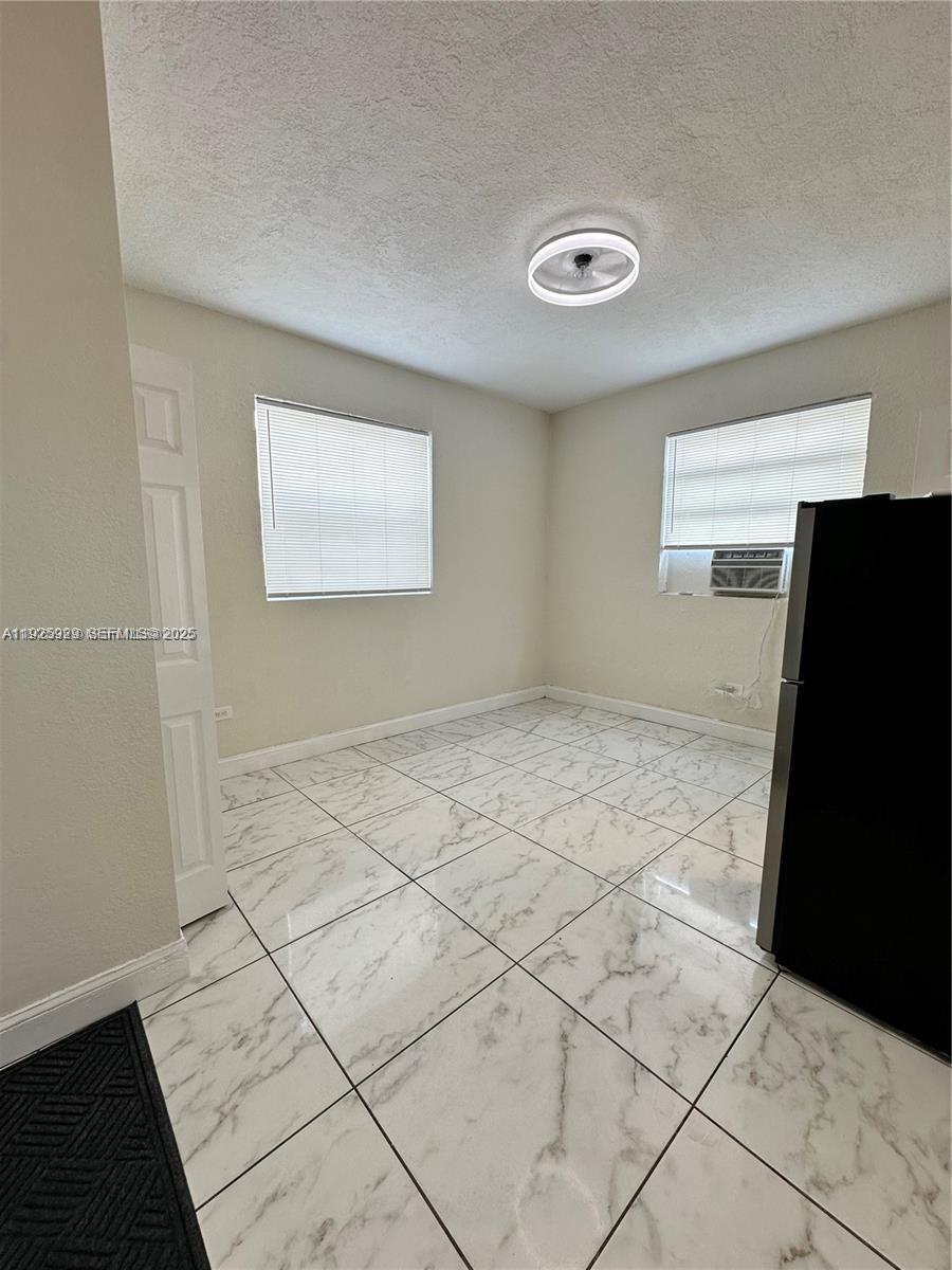 912 Northwest 9th Avenue, Unit 8 Hallandale Beach, FL 33009 - Photo 3 of 10 a view of an empty room and window