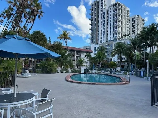 a swimming pool with outdoor seating and yard