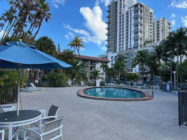 8101 Southwest 72nd Avenue, Unit 312W Miami, FL 33143 - Photo 1 of 19 a swimming pool with outdoor seating and yard