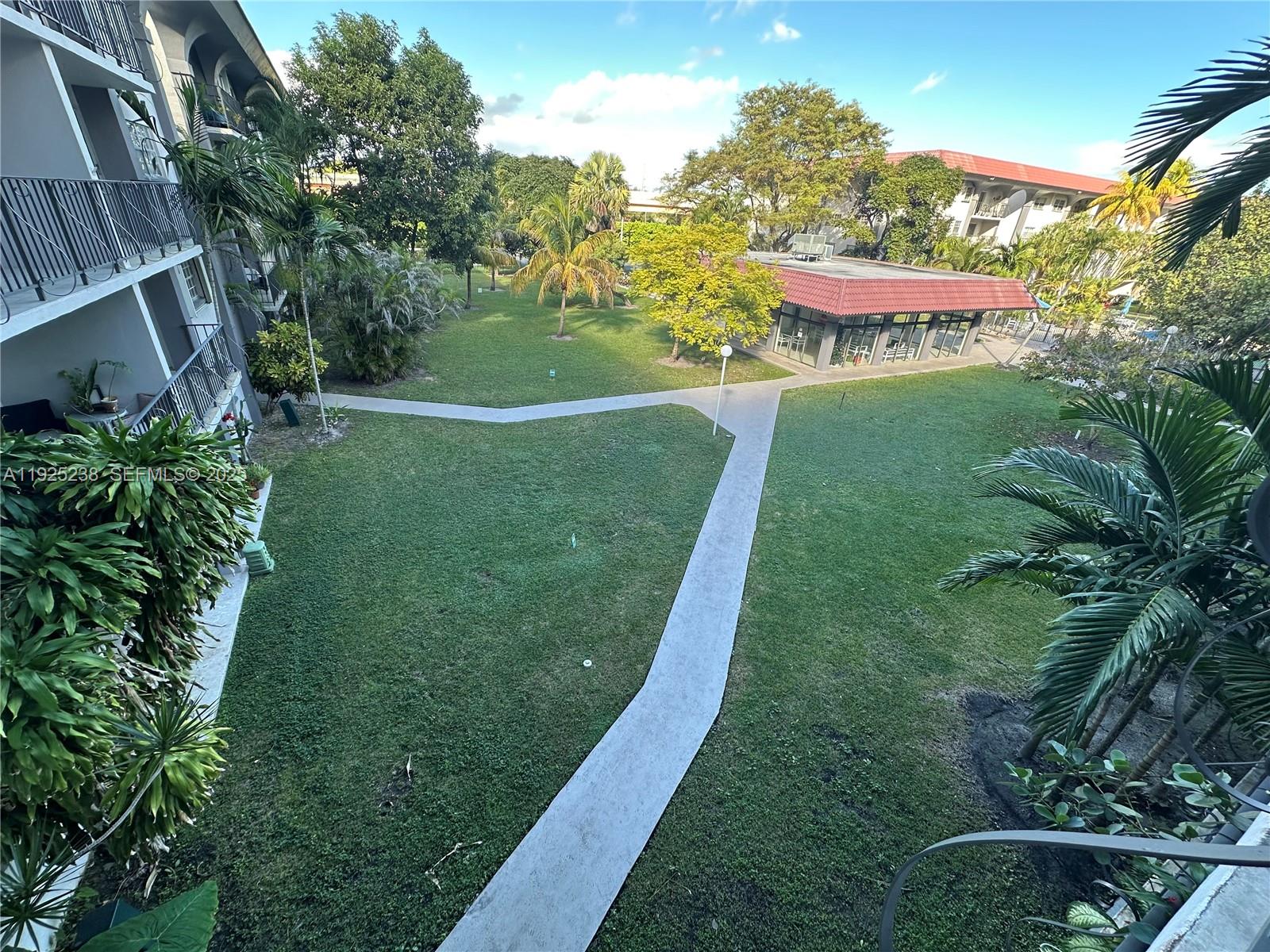 8101 Southwest 72nd Avenue, Unit 312W Miami, FL 33143 - Photo 18 of 19 a view of a house with a yard