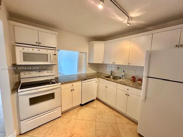 8101 Southwest 72nd Avenue, Unit 312W Miami, FL 33143 - Photo 2 of 19 a kitchen with white cabinets and white appliances