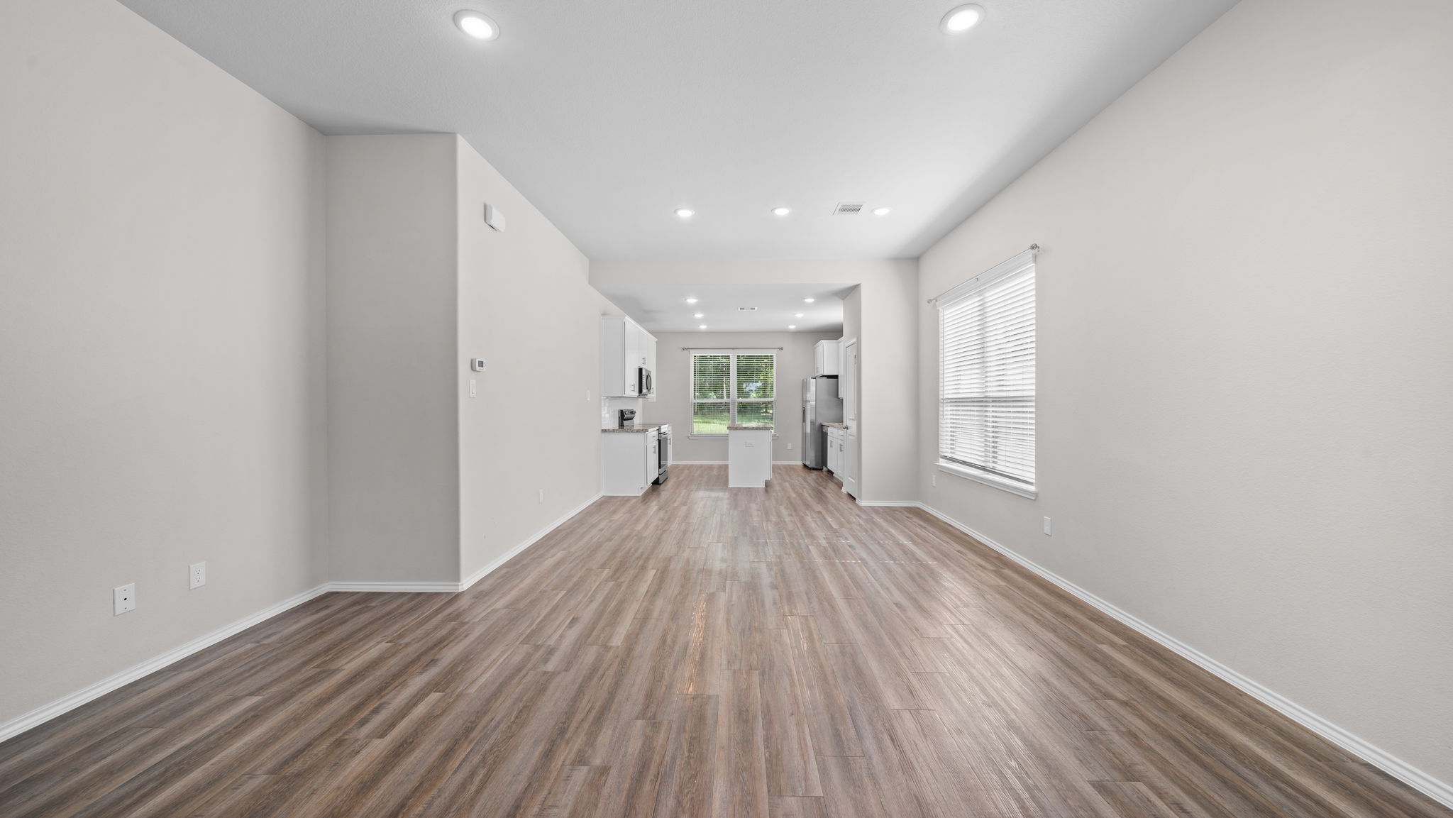 18140 Mail Rte Road Montgomery, TX 77316 - Photo 6 of 26 Enjoy an expansive living room with stylish wood-look flooring, recessed lighting, and an open layout perfect for entertaining.