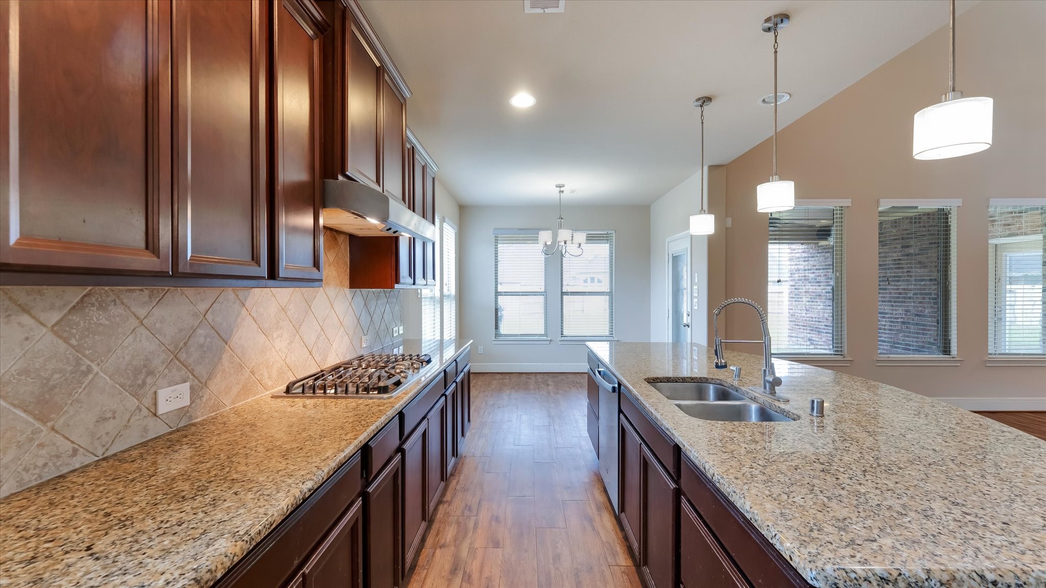 17211 Green Darter Conroe, TX 77385 - Photo 14 of 48 a kitchen with granite countertop a sink stove and cabinets