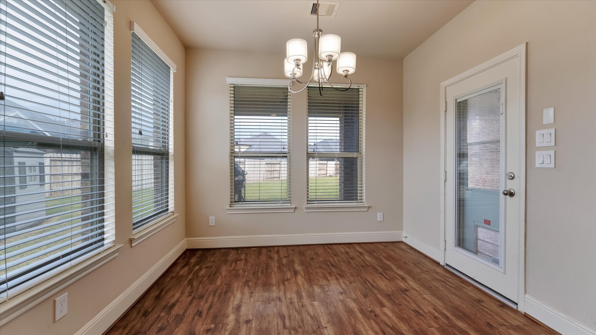 17211 Green Darter Conroe, TX 77385 - Photo 16 of 48 a view of an empty room with wooden floor and a window