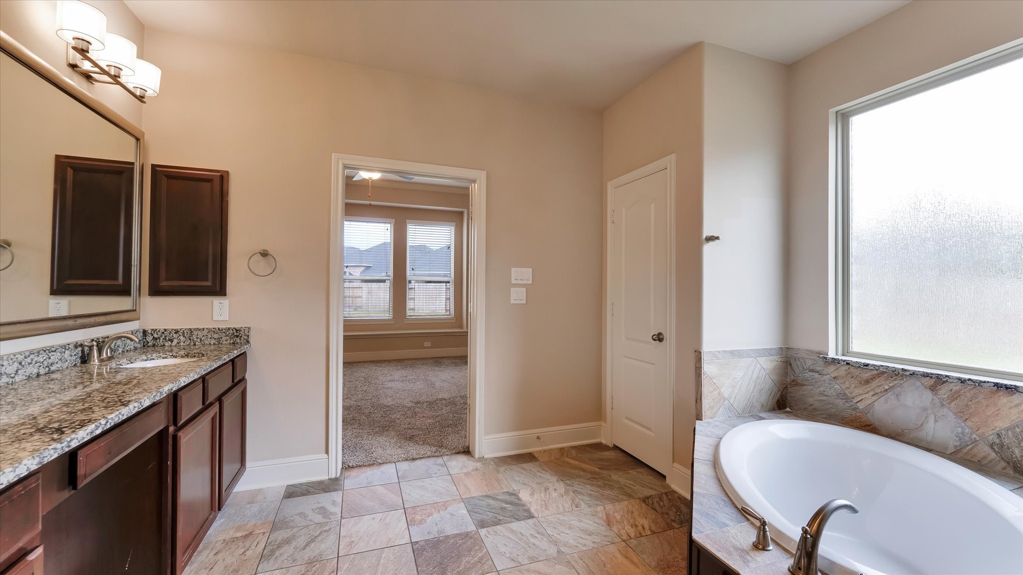 17211 Green Darter Conroe, TX 77385 - Photo 20 of 48 a bathroom with a granite countertop sink and a mirror