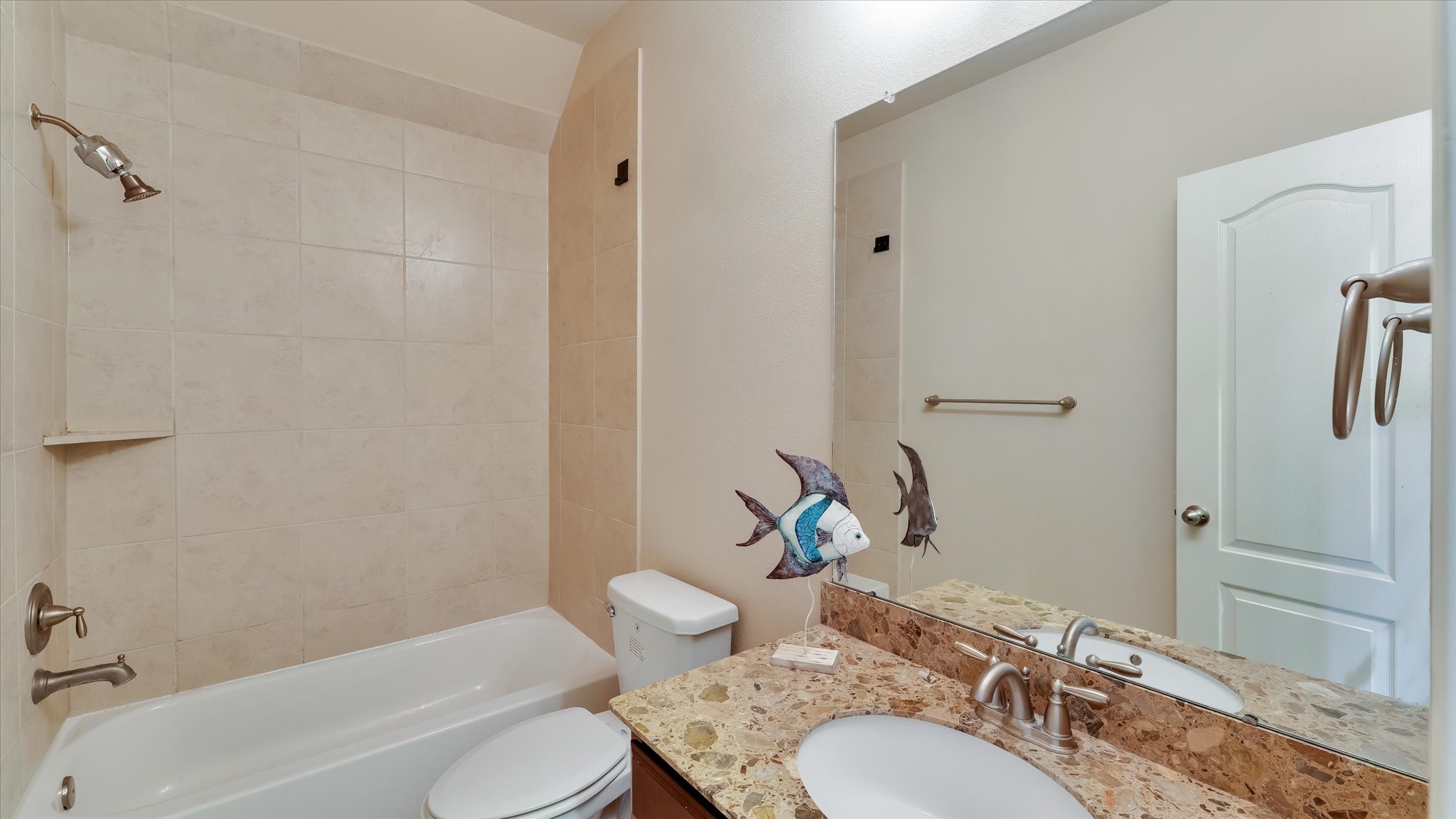 17211 Green Darter Conroe, TX 77385 - Photo 23 of 48 a bathroom with a granite countertop toilet a sink and a bathtub