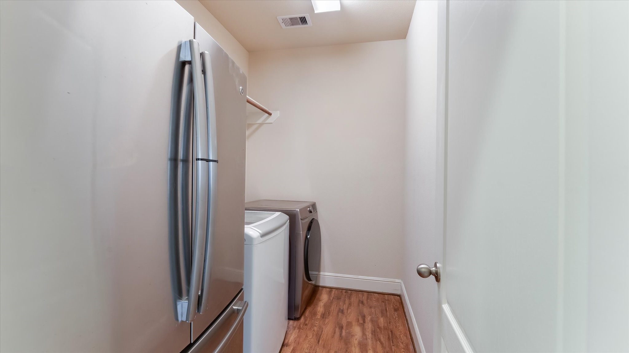 17211 Green Darter Conroe, TX 77385 - Photo 30 of 48 The laundry room features a rod to hang clothes and space for a refrigerator.