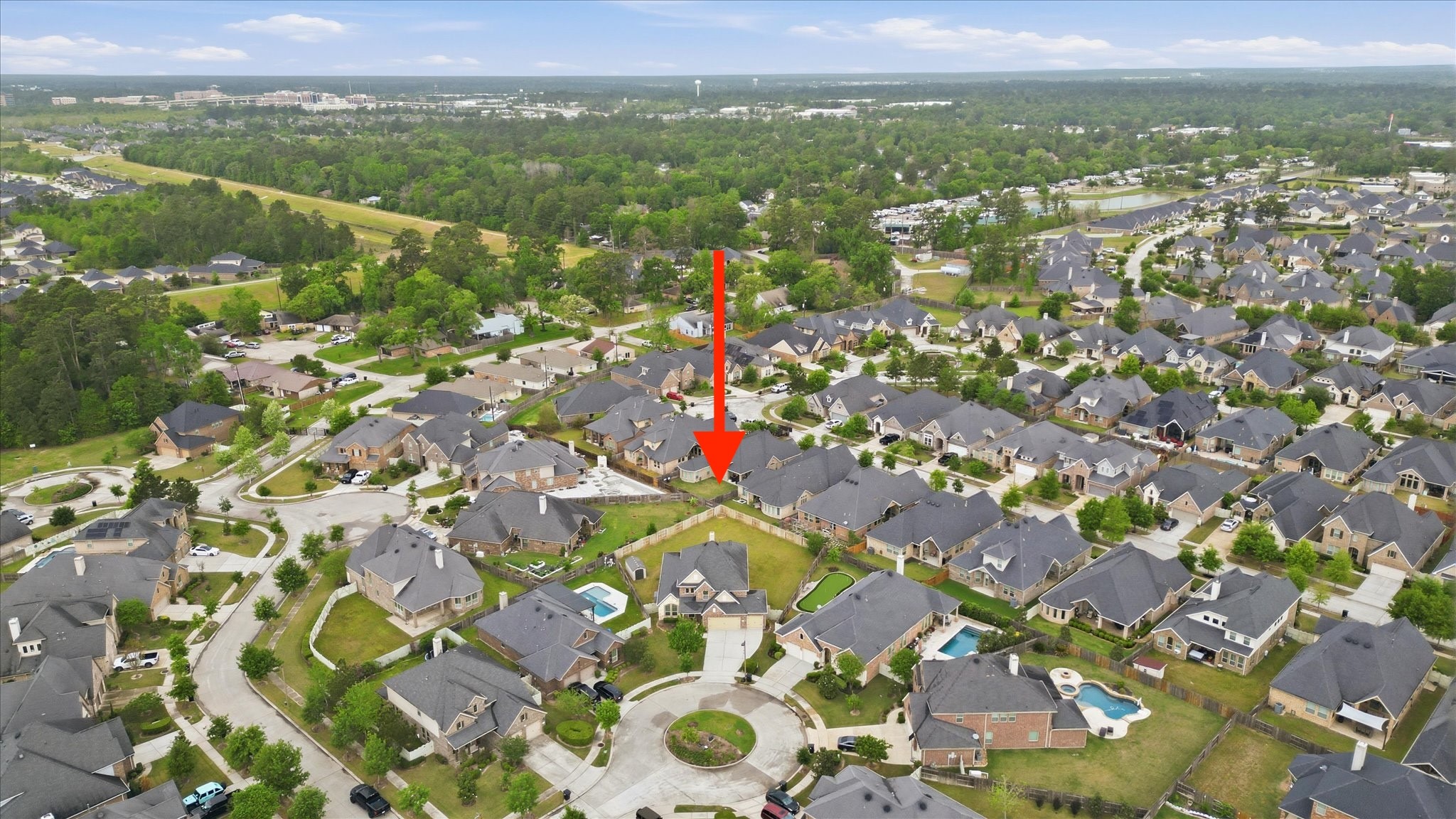 17211 Green Darter Conroe, TX 77385 - Photo 48 of 48 This aerial photo shows a beautiful suburban neighborhood with spacious, well-maintained homes. The highlighted property is centrally located, featuring a large yard and close proximity to other attractive houses. The area is lush and green, providing a peaceful and welcoming environment.