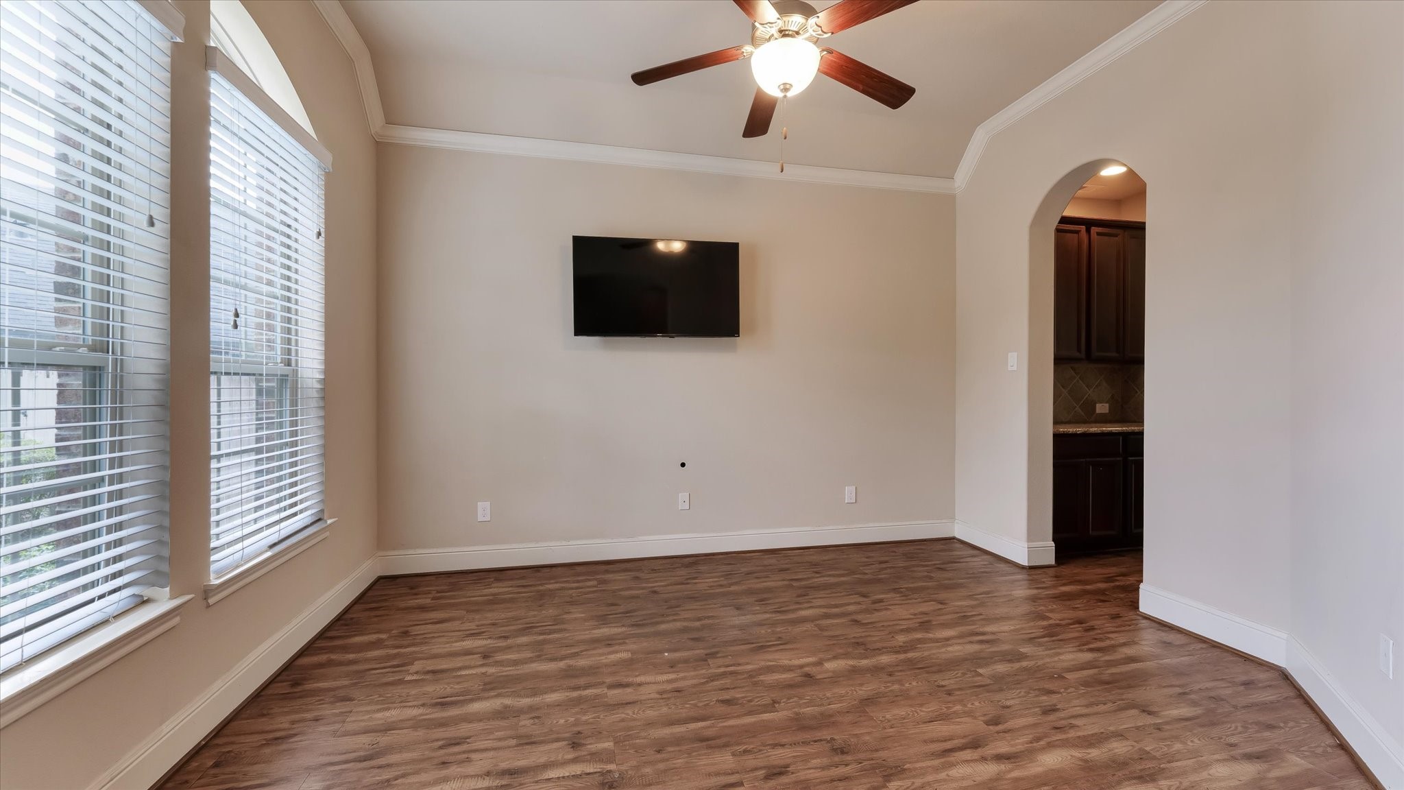 17211 Green Darter Conroe, TX 77385 - Photo 9 of 48 an empty room with wooden floor fan and windows