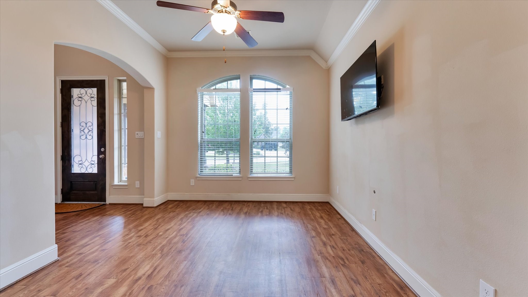17211 Green Darter Conroe, TX 77385 - Photo 10 of 48 an empty room with wooden floor fan and windows