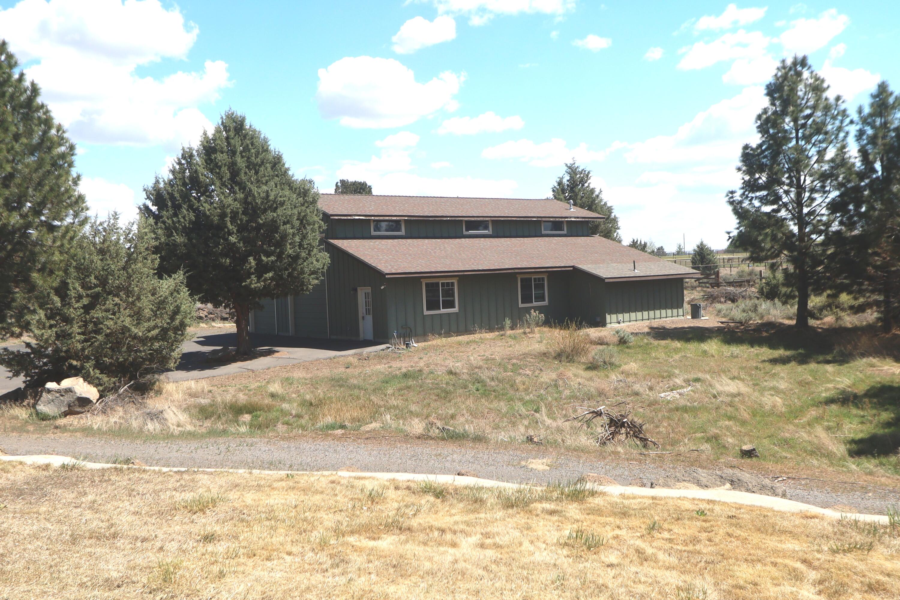 21491 Bear Creek Road Bend, OR 97701 - Photo 33 of 45 a front view of a house with a yard
