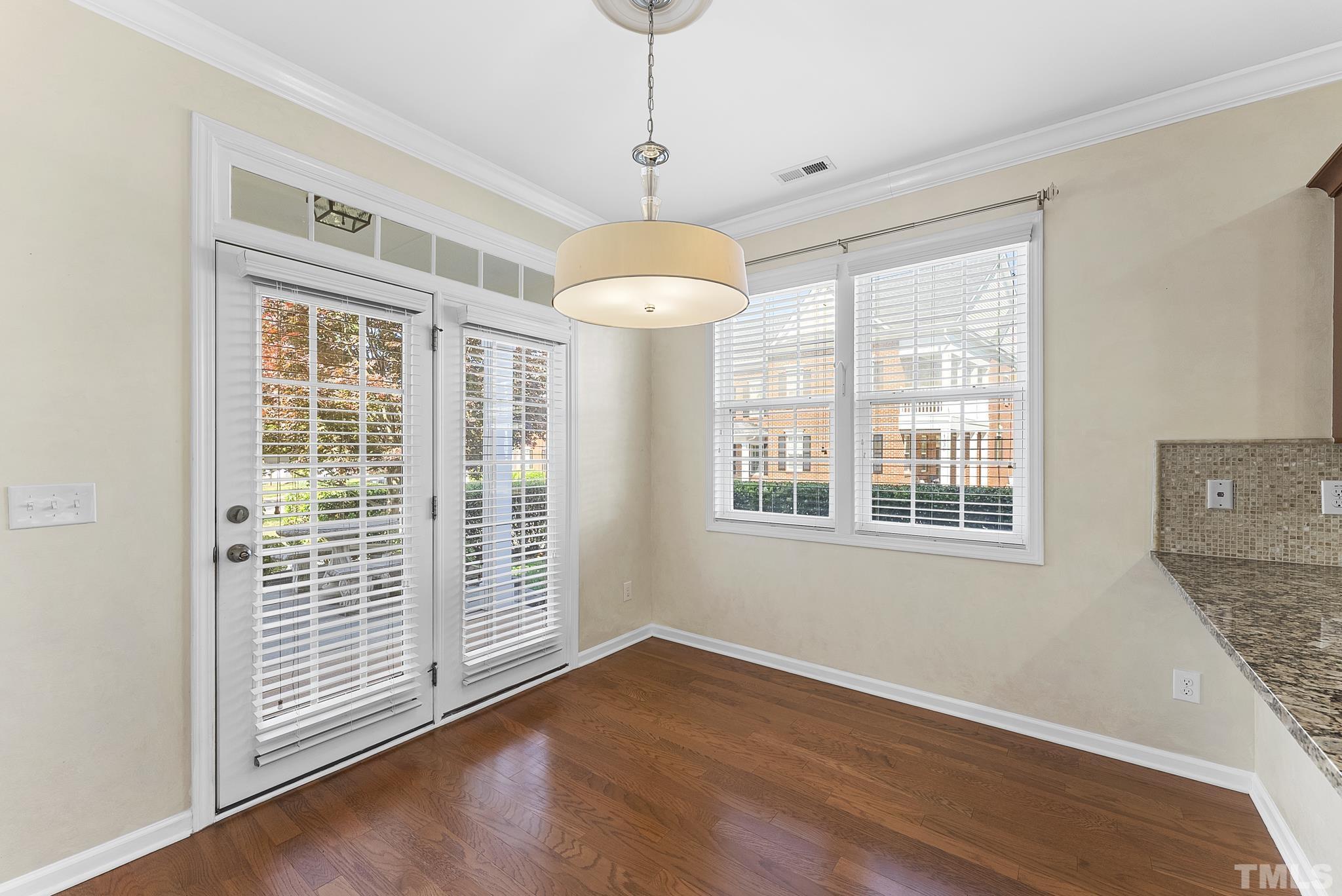517 Dragby Lane Raleigh, NC 27603 - Photo 12 of 31 a view of an empty room with a window and wooden floor