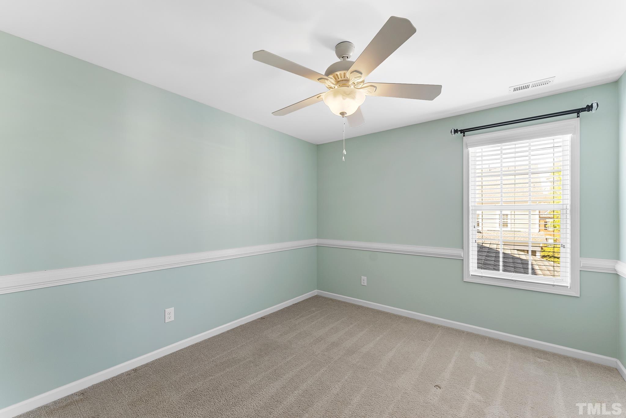 517 Dragby Lane Raleigh, NC 27603 - Photo 15 of 31 an empty room with a window and a fan