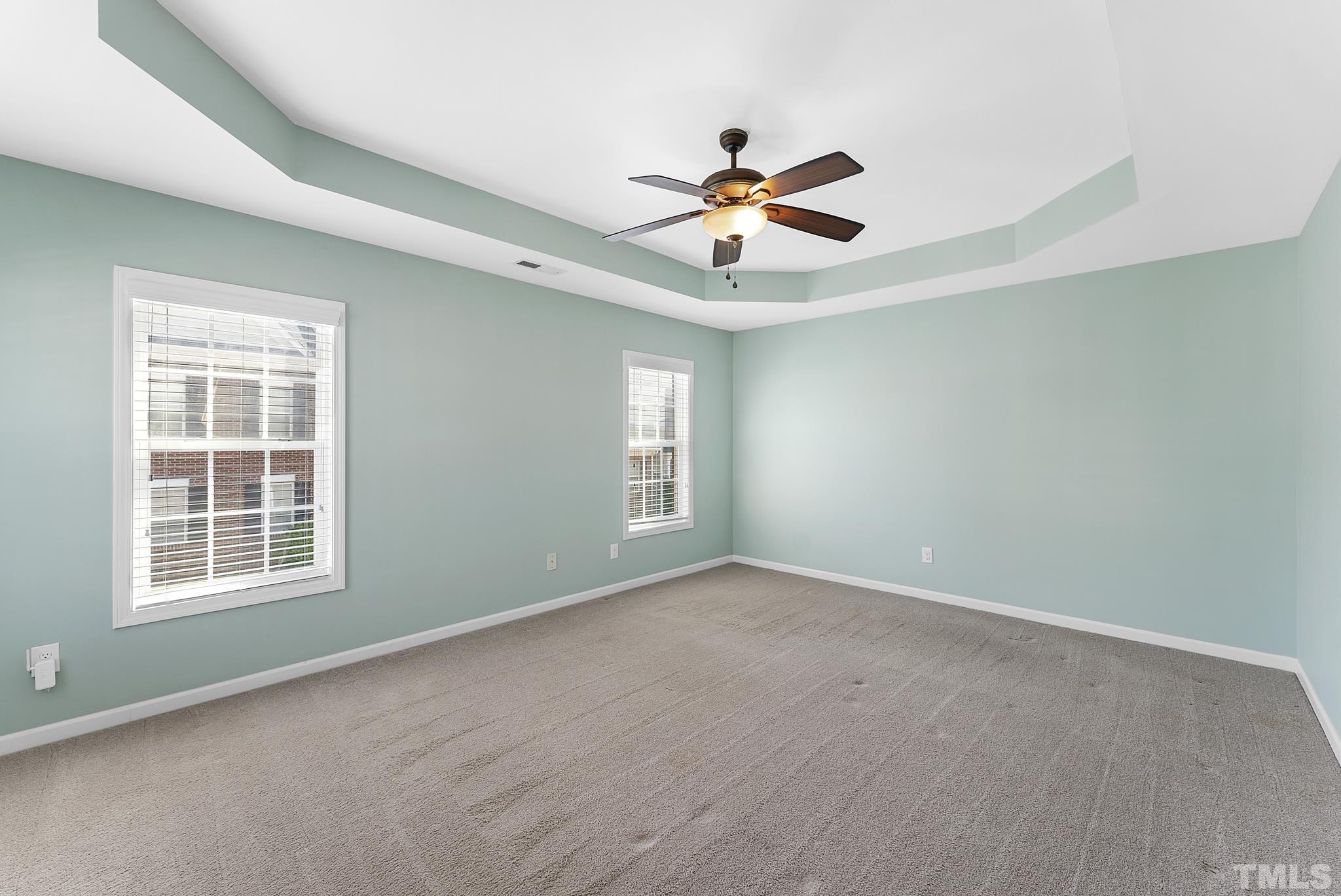 517 Dragby Lane Raleigh, NC 27603 - Photo 21 of 31 an empty room with windows and ceiling fan