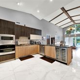a kitchen with stainless steel appliances kitchen island granite countertop a refrigerator and stove top oven