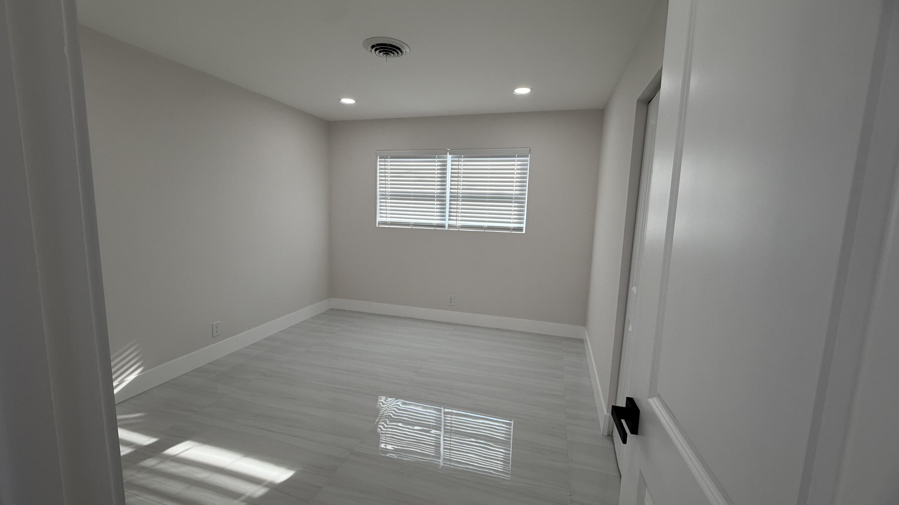 2521 Northeast 45th Street Lighthouse Point, FL 33064 - Photo 19 of 25 an empty room with windows