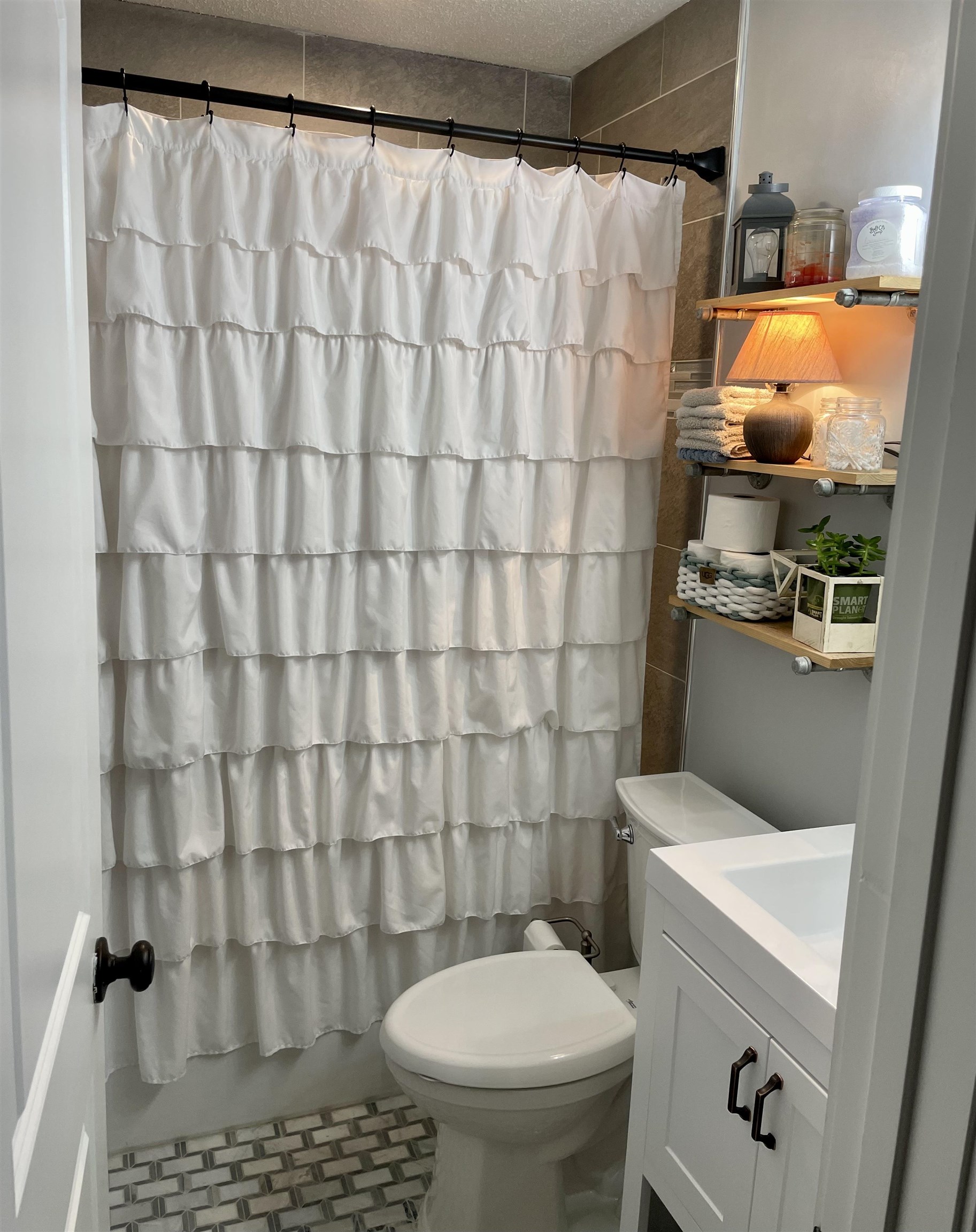 5065 Flamingo Road Memphis, TN 38117 - Photo 8 of 18 a bathroom with a toilet and a shower curtain