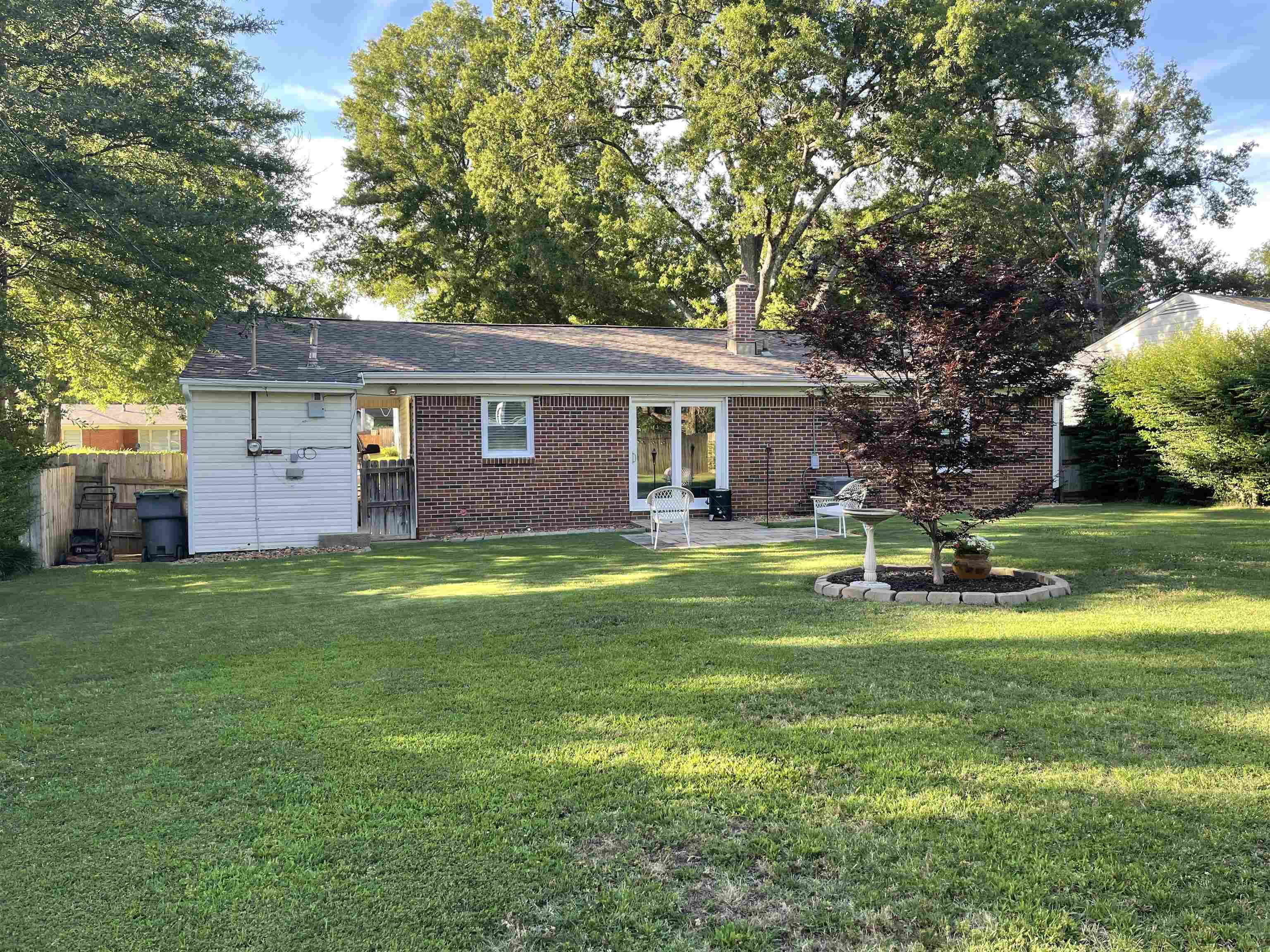 5065 Flamingo Road Memphis, TN 38117 - Photo 10 of 18 a front view of a house with a yard table and chairs