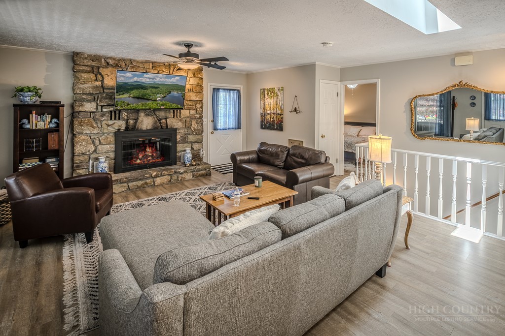 38 Rocky Meadows Road Newland, NC 28657 - Photo 6 of 50 a living room with furniture a flat screen tv and a fireplace