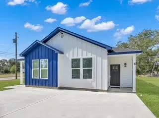 a view of house with backyard and garden