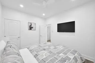 a bedroom with a bed and a flat screen tv