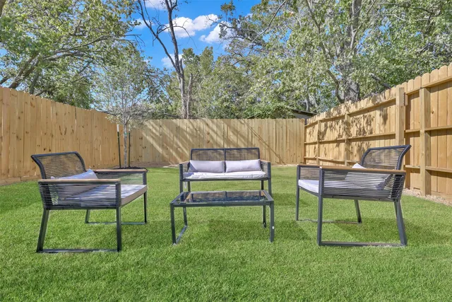 a backyard of a house with table and chairs