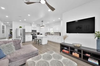 211 South 5th Street, Unit B Conroe, TX 77301 - Photo 2 of 14 a living room with furniture and a flat screen tv